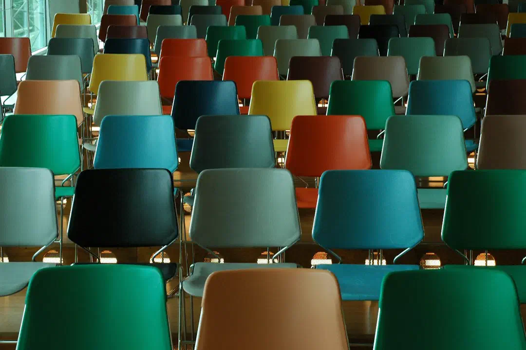 Rows of empty plastic chairs in many different colours