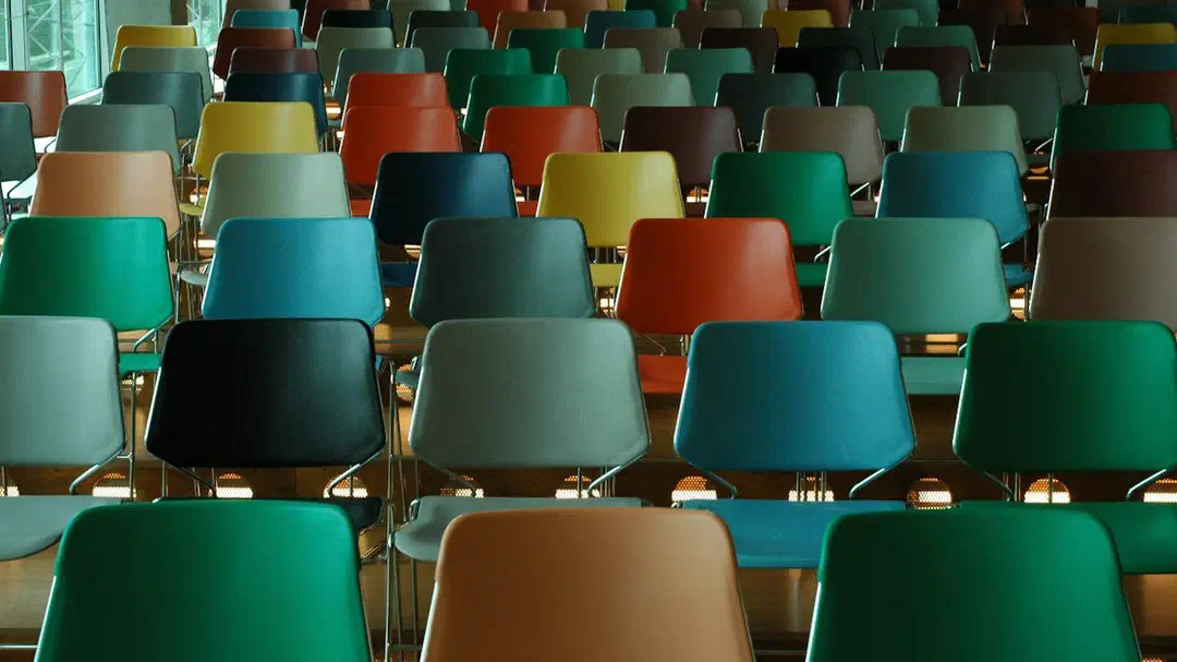 Rows of empty plastic chairs in many different colours