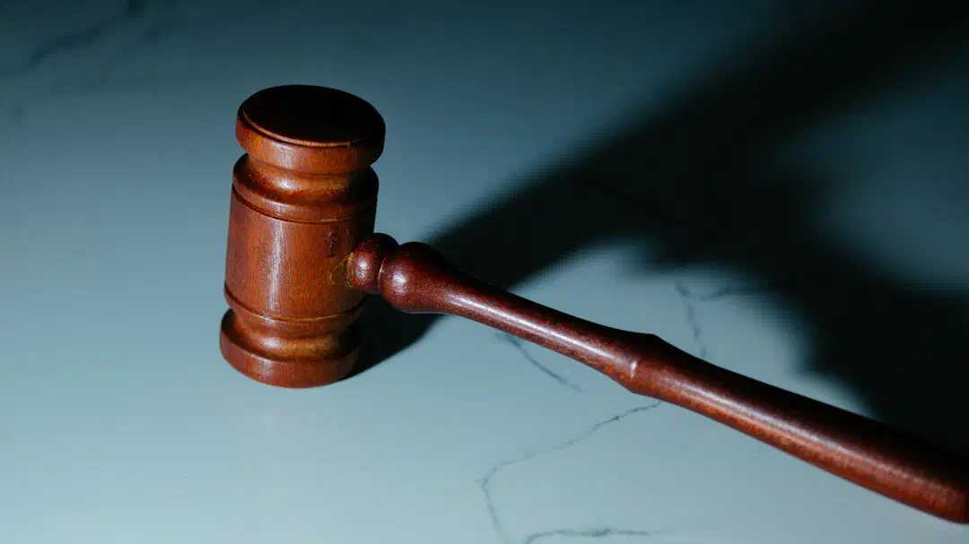 A wooden judge's gavel resting on a table