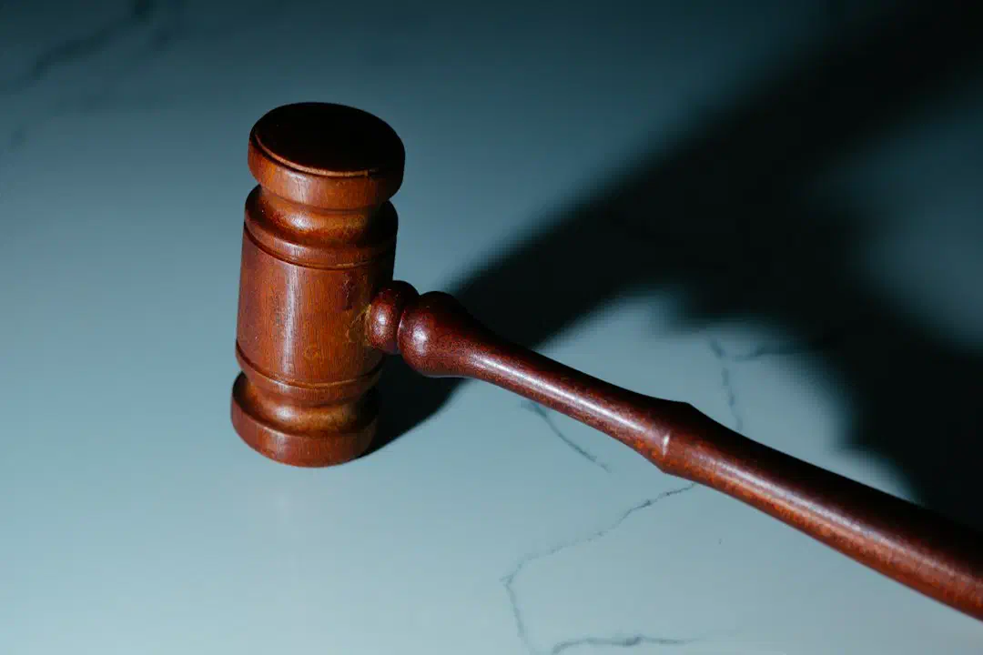 A wooden judge's gavel resting on a table