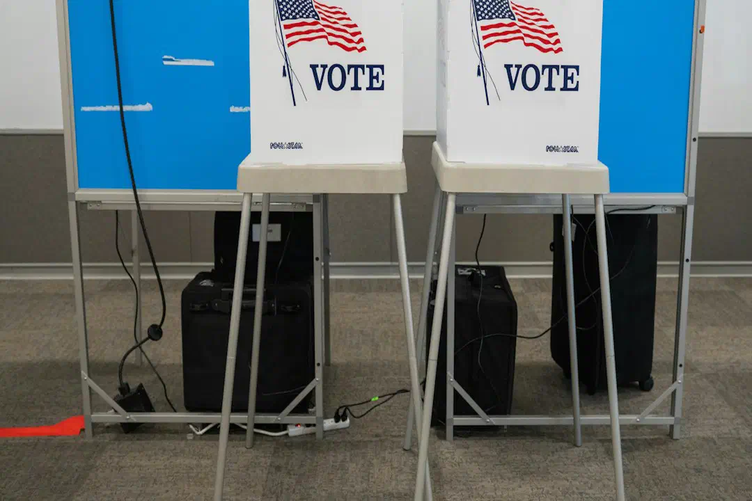 Two voting booths set up in a library hall