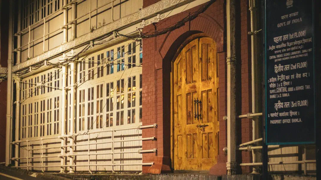 A historic building with a wooden door and an official sign