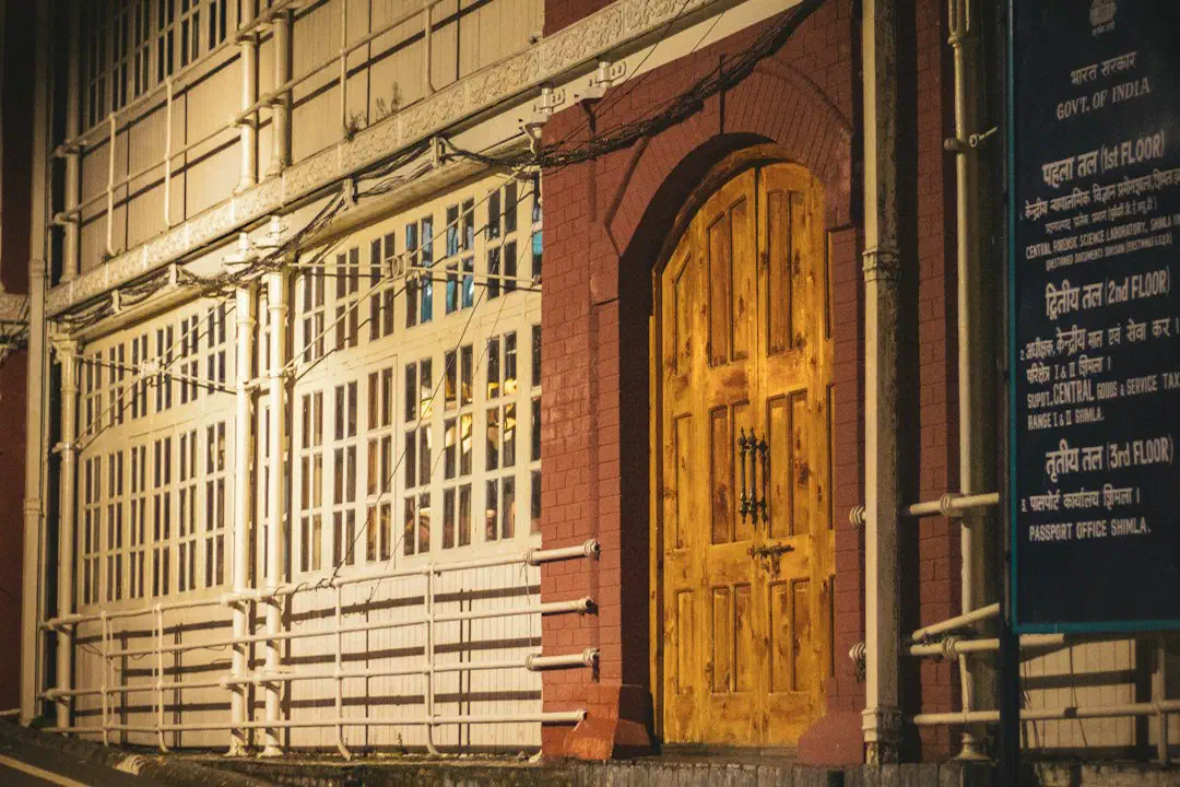 A historic building with a wooden door and an official sign