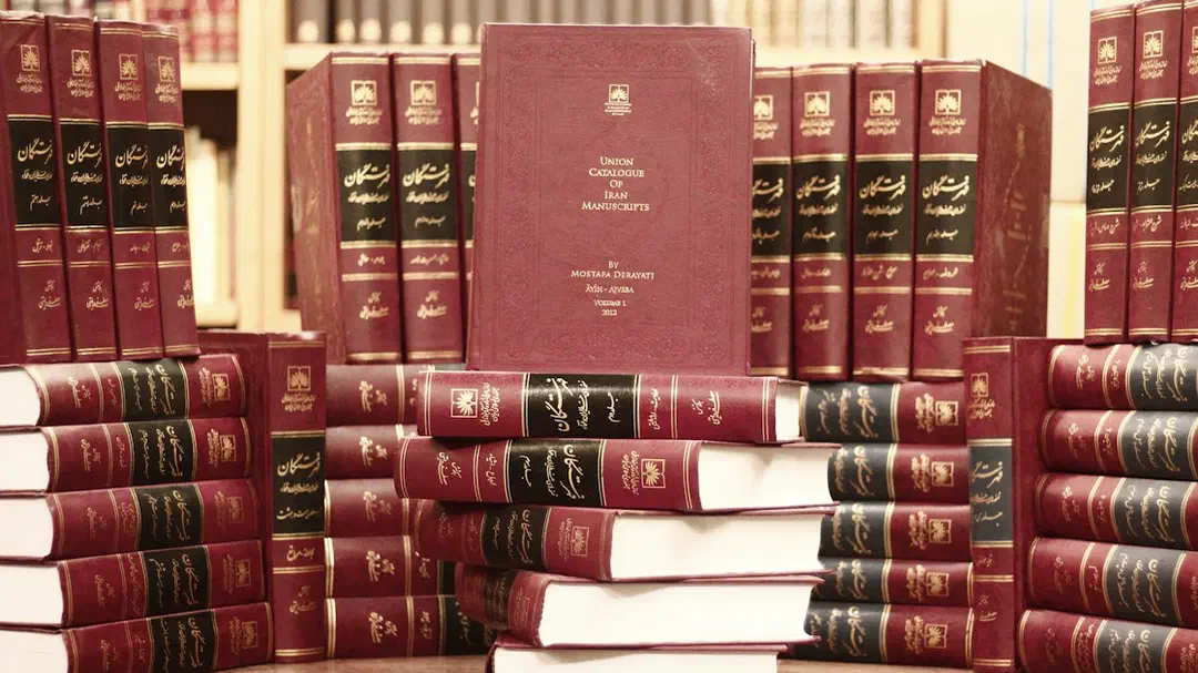A stack of red books on a wooden table
