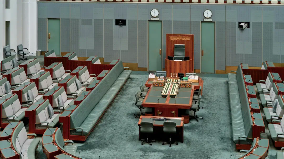 Rows of empty seats in a legislative chamber