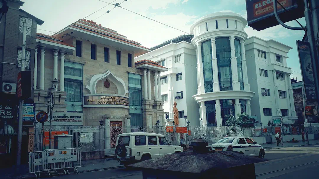 A street with cars and buildings on either side in Kolkata