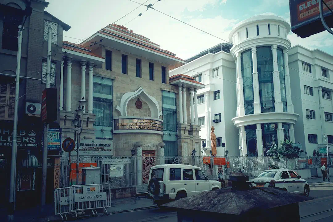A street with cars and buildings on either side in Kolkata