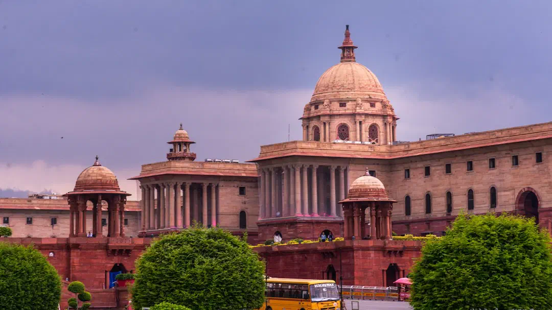 A grand building with domes and manicured gardens