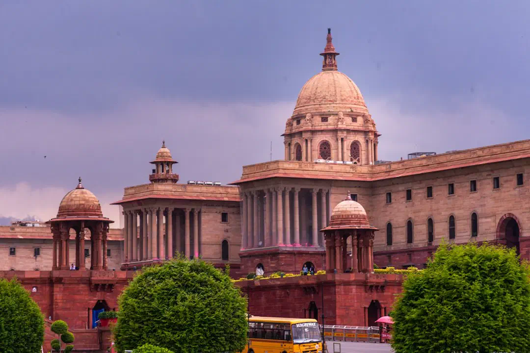 A grand building with domes and manicured gardens