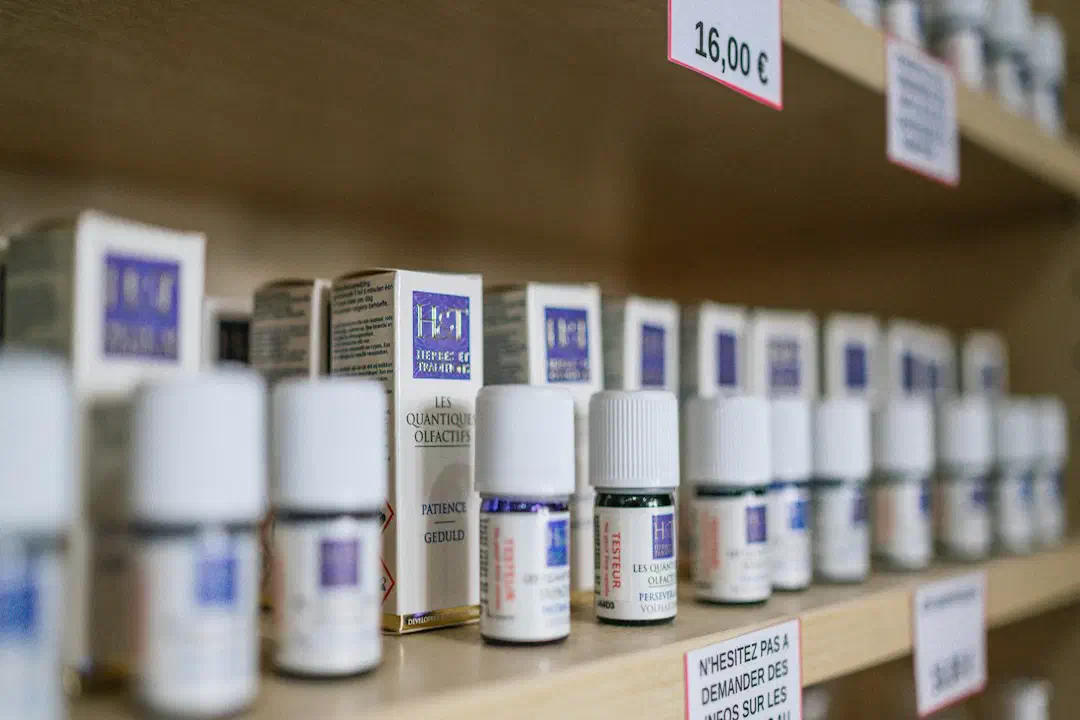 White plastic medicine bottles on a brown wooden shelf