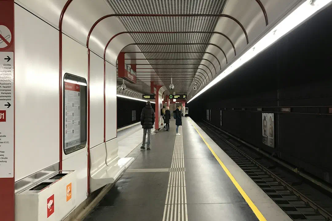 A red-lit tunnel along a metro train track