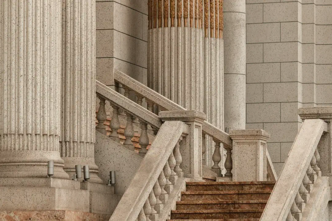 A stone staircase leading up to a building with tall classical columns